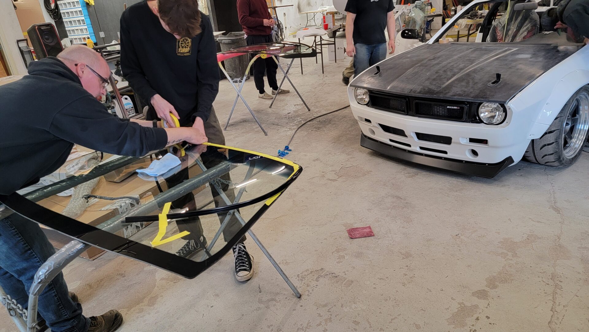 Employee prepping windshield